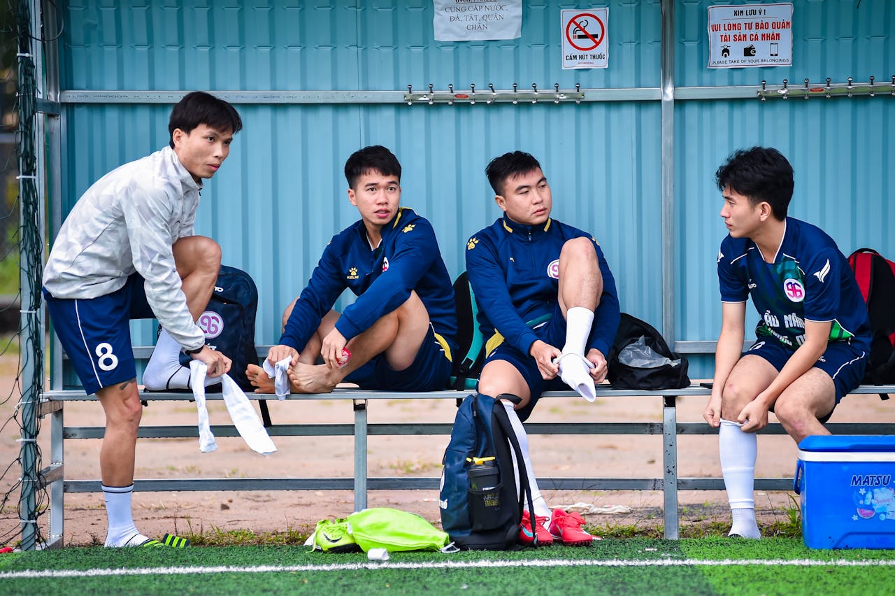 Home Four young men in sports gear prepare for a football match in Hanoi, Vietnam.